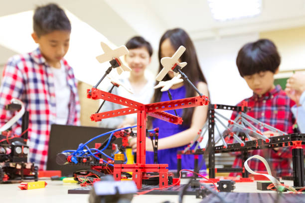 istock Park ride model at desk with students in school 1210518881