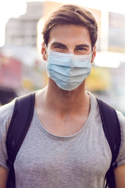 Man with in coronavirus infected city wearing a surgical mask