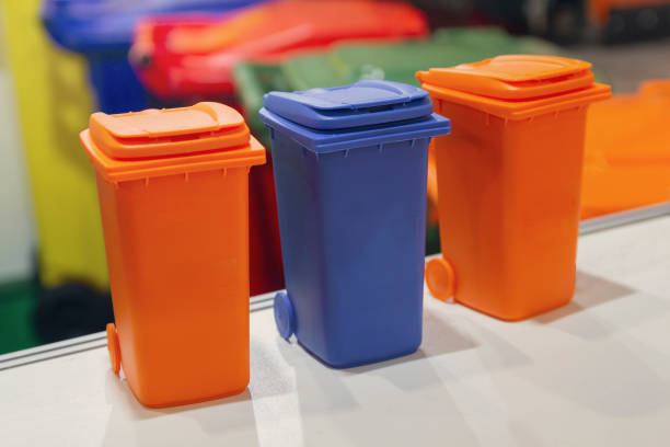 istock Miniature color garbage containers on the table. Ecology 1210520618