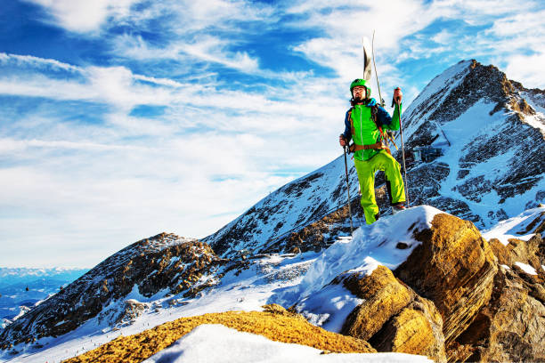 istock Ski climber at sunset on rocky ridge 1210522145