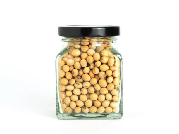 istock Soybeans in glass jar isolated on white background. 1210522341