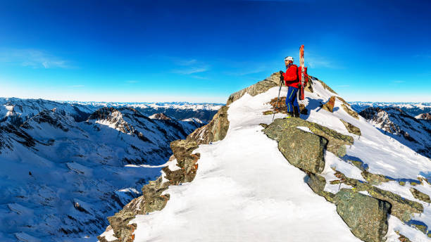 istock Ski mountaineer looks down into the valley 1210522417