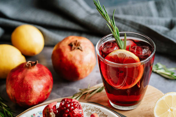 istock Pomegranate drink in a glass with lemon and rosemary 1210523540