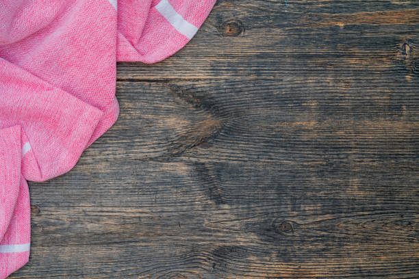 istock Red and white kitchen towel lies on wooden table. 1210525095