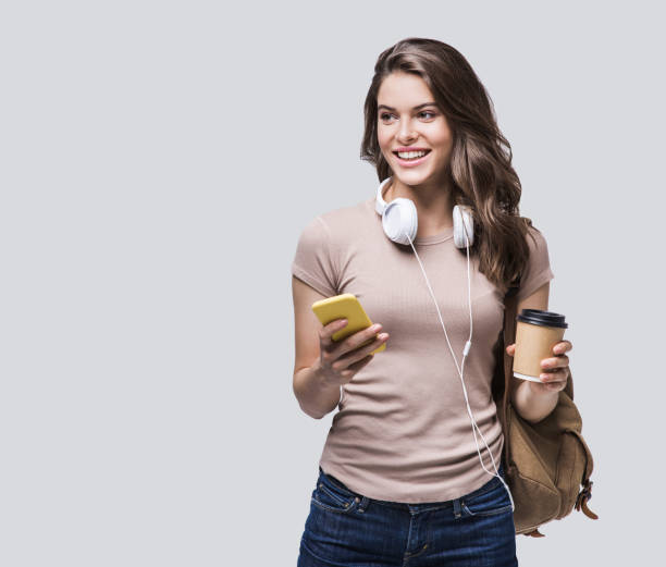istock Happy student girl using smart phone going on travel 1210525233