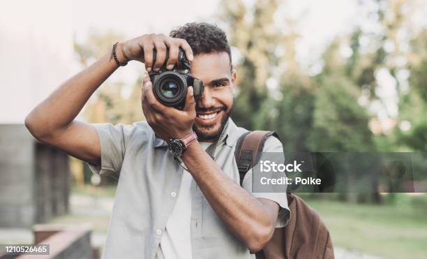Young Man Photographer Taking Pictures In A City Stock Photo - Download Image Now - Photographer, Photographing, Camera - Photographic Equipment