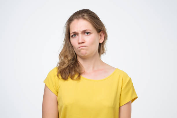 istock Serious caucasian woman frowning her face and looking at camera with mistrust. 1210526607