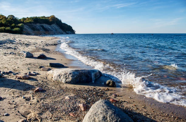 istock seackape with sea waves breaking down on a large stone 1210526802