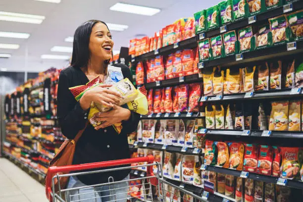 Shot of a young woman shopping in a grocery store