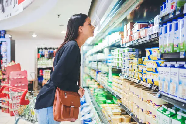 Shot of a young woman shopping in a grocery store