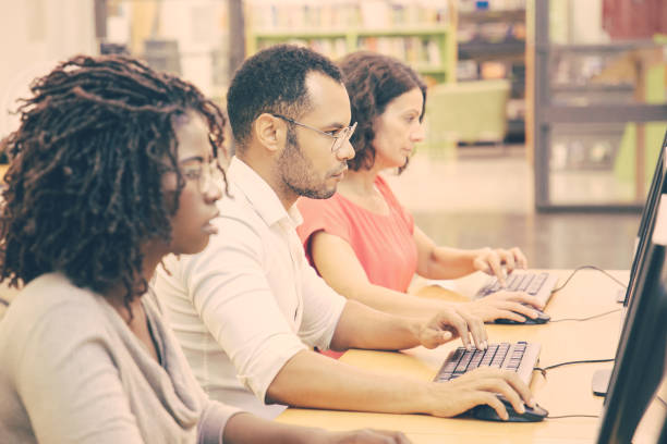 istock Diverse group of adult students working in computer class 1210531439