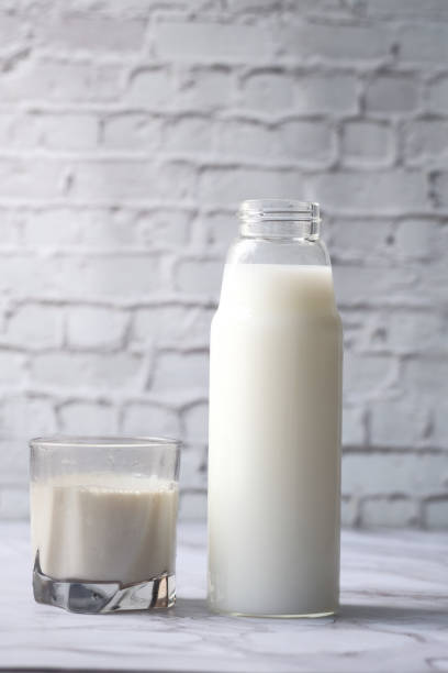 istock fresh milk in a glass and bottle on table 1210532612