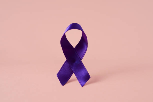 istock purple ribbon on a pink background 1210532800