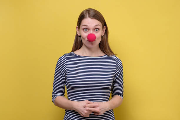 istock Funny young girl with a red clown nose 1210534883