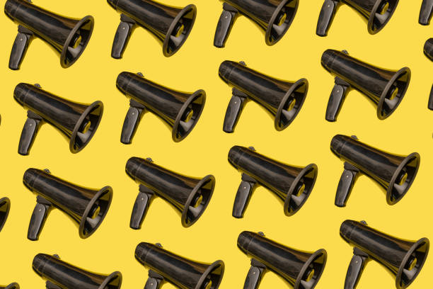 istock Collage of black load speaker on yellow backboard, wake up Concept 1210535245