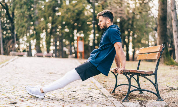 Men exercising working out triceps and biceps doing dips