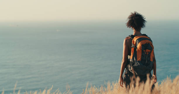 You come across so much beauty when you walk in nature Rearview shot of a young woman looking at the view while out on a hike vista posterior stock pictures, royalty-free photos & images