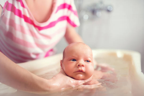 istock Hands of a careful mother hold boy 1210536106