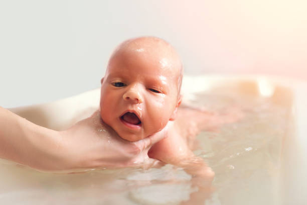istock Hands of a careful unknown mother hold boy 1210536114