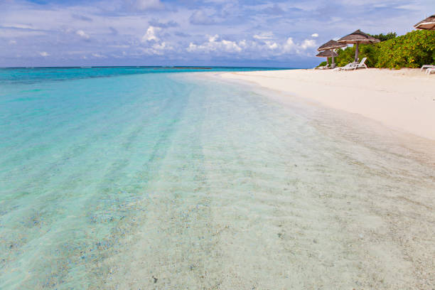 istock Turquoise blue sea water shore and cloudy sky 1210536202