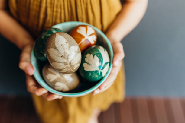 istock Young girl holds naturally dyed easter eggs 1210542249
