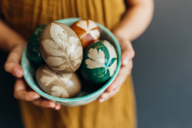istock Young girl holds naturally dyed easter eggs 1210542377