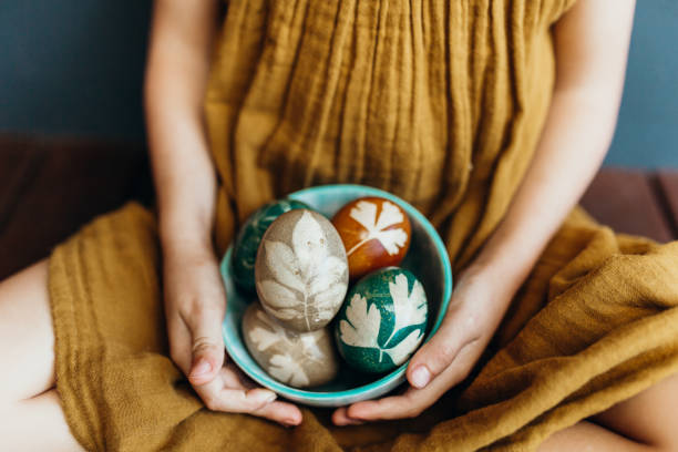 Young girl holds naturally dyed easter eggs