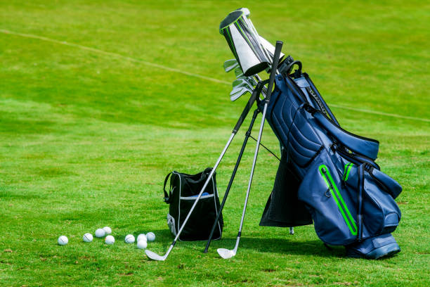 Bag of golf clubs on the golf course stock photo