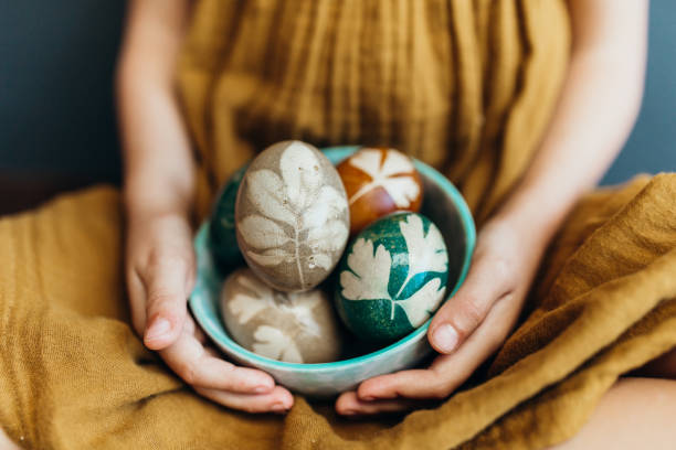 istock Young girl holds naturally dyed easter eggs 1210543178