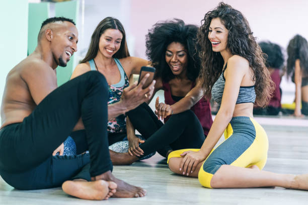 istock Group of dancers sitting and rest on floor and using smart phone 1210543805