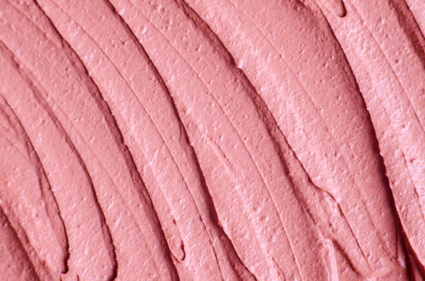 istock Pale pink cosmetic clay (rhassoul, facial mask, face cream, body wrap) texture close up, selective focus. Abstract background with brush strokes. 1210544908