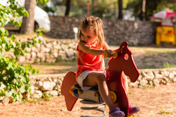 istock Cute girl playing at playground 1210544951