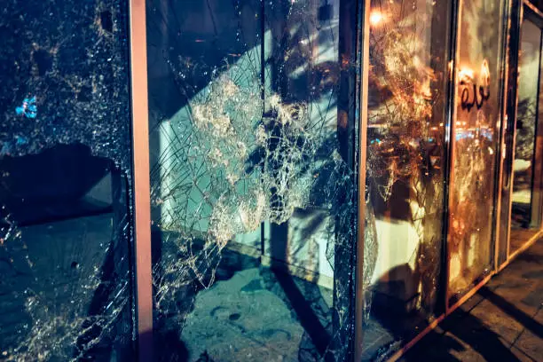 Photojournalism, broken shopfront, crime night scene, the background of a damaged showcase of shops, the consequences of revolution, Beirut, Lebanon