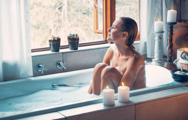 istock Woman with pleasure taking bath with foam 1210545383