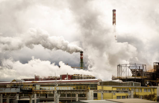 Industrial chimneys Smoke emissions escaping out of large industrial chimneys from a factory emission nebula stock pictures, royalty-free photos & images