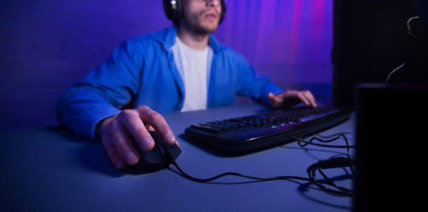 istock Unrecognizable Man Playing Computer Games Overnight Sitting Indoor, Cropped, Panorama 1210545484