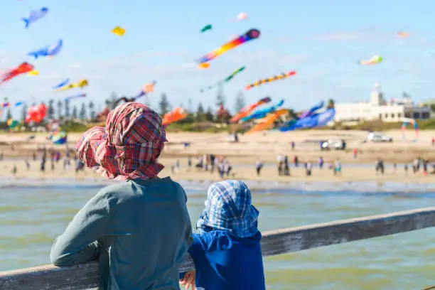 Children watching flying kites from Semaphore Jetty, South Australia
