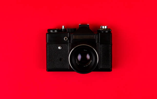 istock Flat lay film camera isolated on red background. Copy space 1210546264