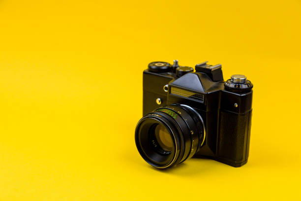 istock Flat lay film camera isolated on yellow background. Copy space 1210546307
