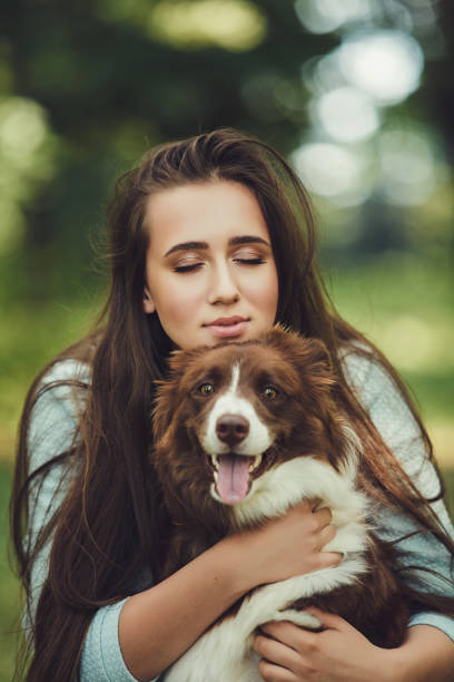 istock girl playing with her dog 1210547020