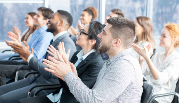 istock Grateful listeners. Business audience applauding to speaker 1210547212