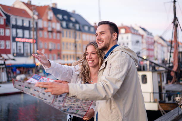 istock Adventorous young tourist couple looking at what direction to go 1210548206