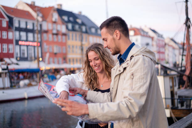 istock Cheerful young couple looking at city map 1210548209