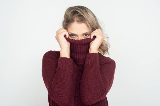 istock Woman wearing turtleneck and looking at camera 1210548371
