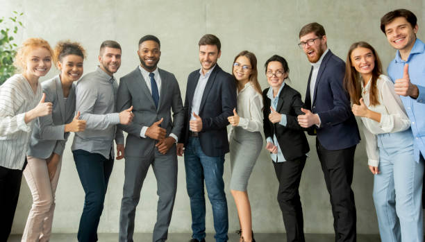 istock Cheerful young business team showing thumbs up 1210548404
