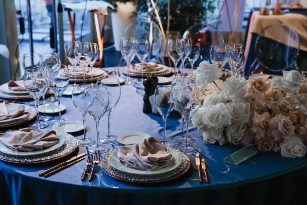 istock Glasses, forks, knives, plates on a table in restaurant served for dinner 1210548444