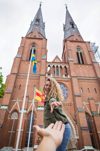 Excited young woman visiting Uppsala Cathedral