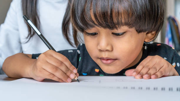 istock Headshot of young boy drawing 1210549359