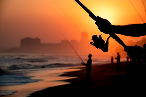 a man fishing at sunset