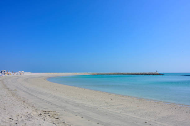 istock Sand beach over blue sea water and sky 1210549496